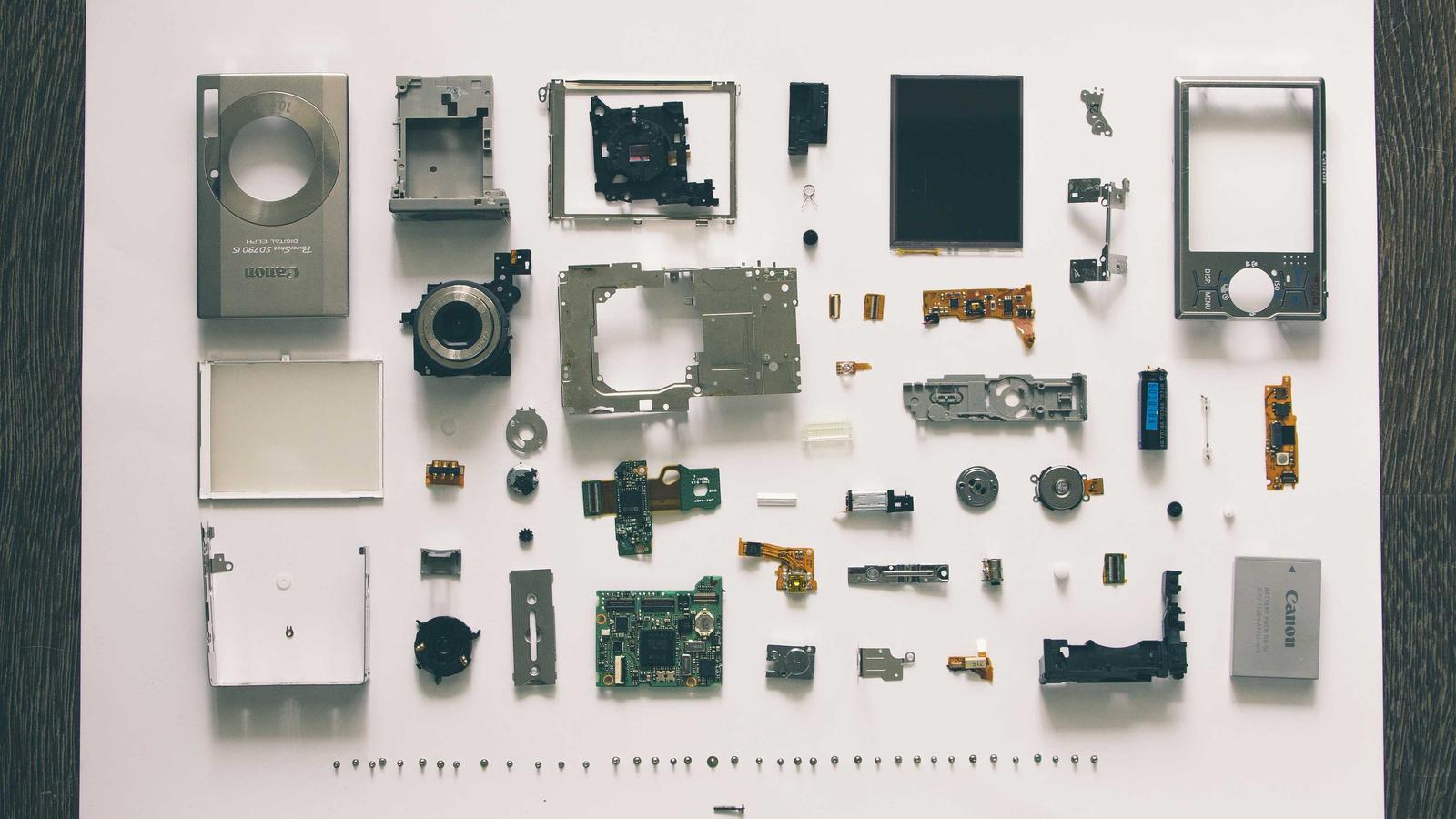 Neatly arranged gadgets and tools laid out on a white surface