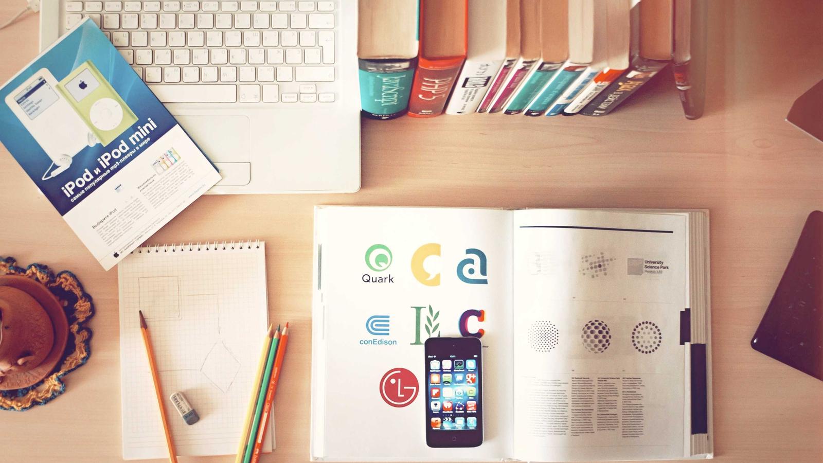 Desk flat-lay with charts, notes and a phone